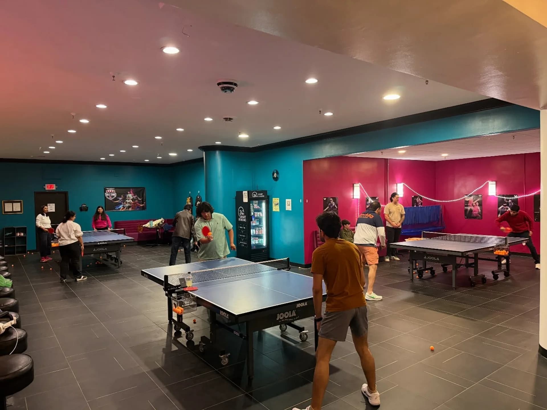 A full house — every table in use, spectators along the wall