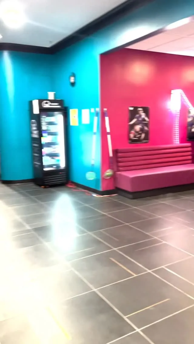 The magenta wall and booth seating at the far end of the club
